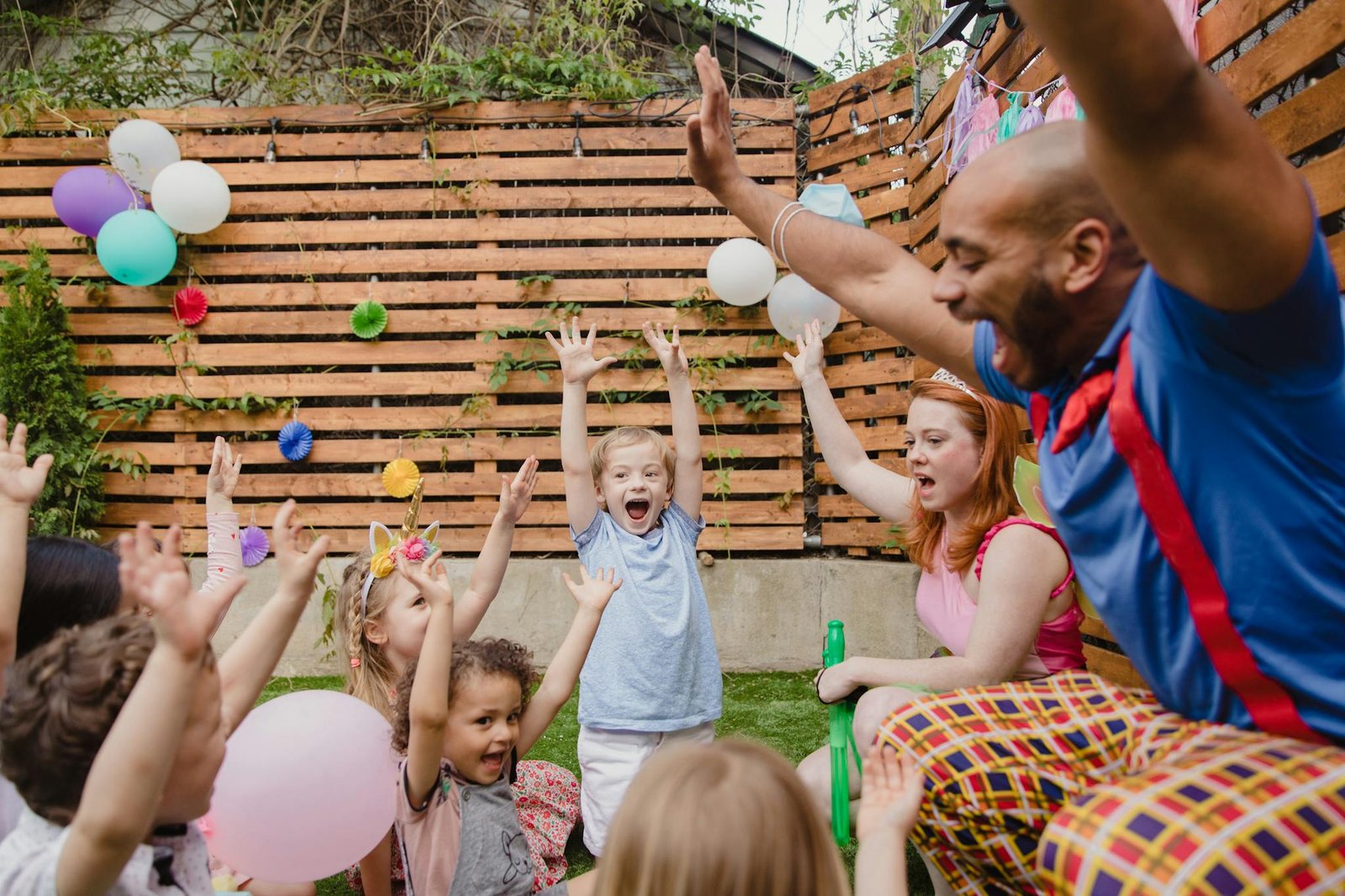 Kids and adults having fun at a lively outdoor birthday party.