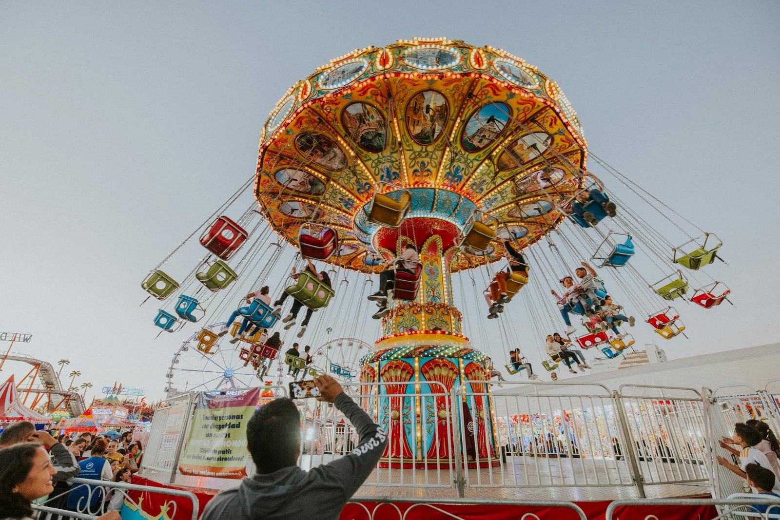 Vibrant carousel swing ride at an amusement park in León, Mexico, teeming with fun and joy.